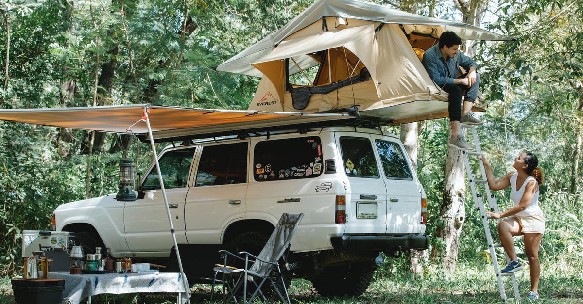 How flexible are US car rental companies with pickup/drop off times? - Happy young multiracial couple spending time in forest during camping in summer