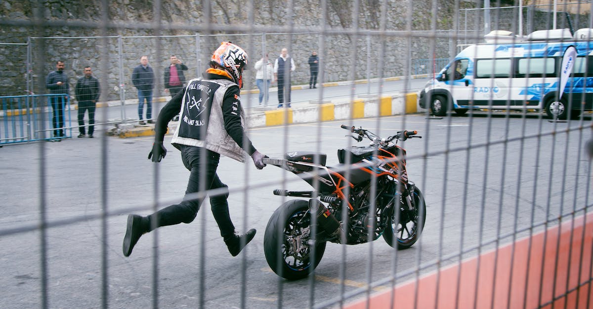 How good are Aeroflot's current safety and performance standards? - Man Holding Orange and Black Sports Bike on Asphalt Road