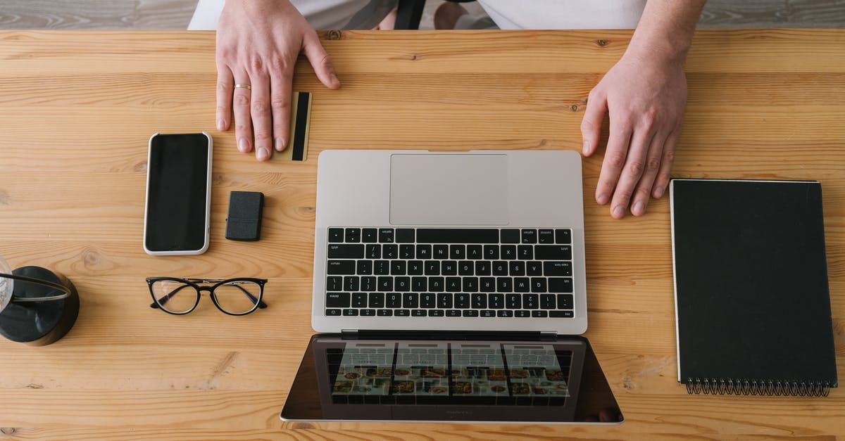 How good is credit card acceptance in Czech Republic? - Person Using Macbook Pro on Brown Wooden Table