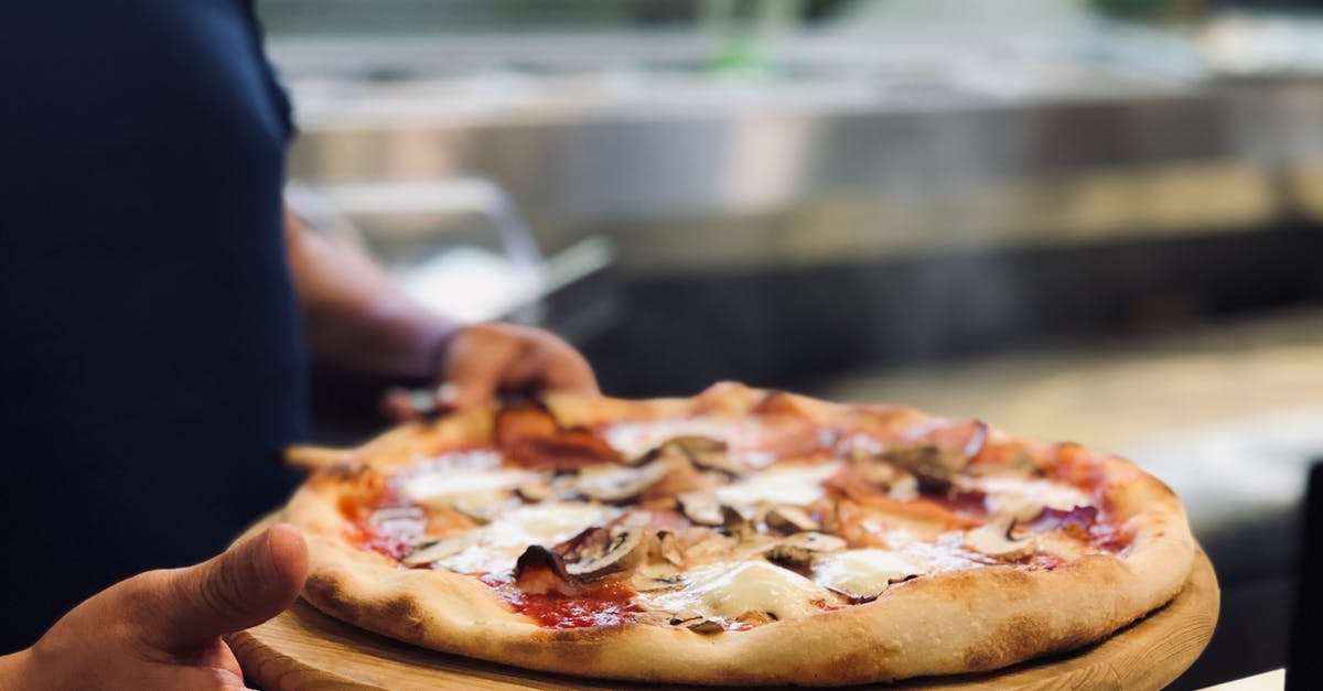 How hot in Italy on June? [duplicate] - Person Holding Whole Pan of Baked Pizza