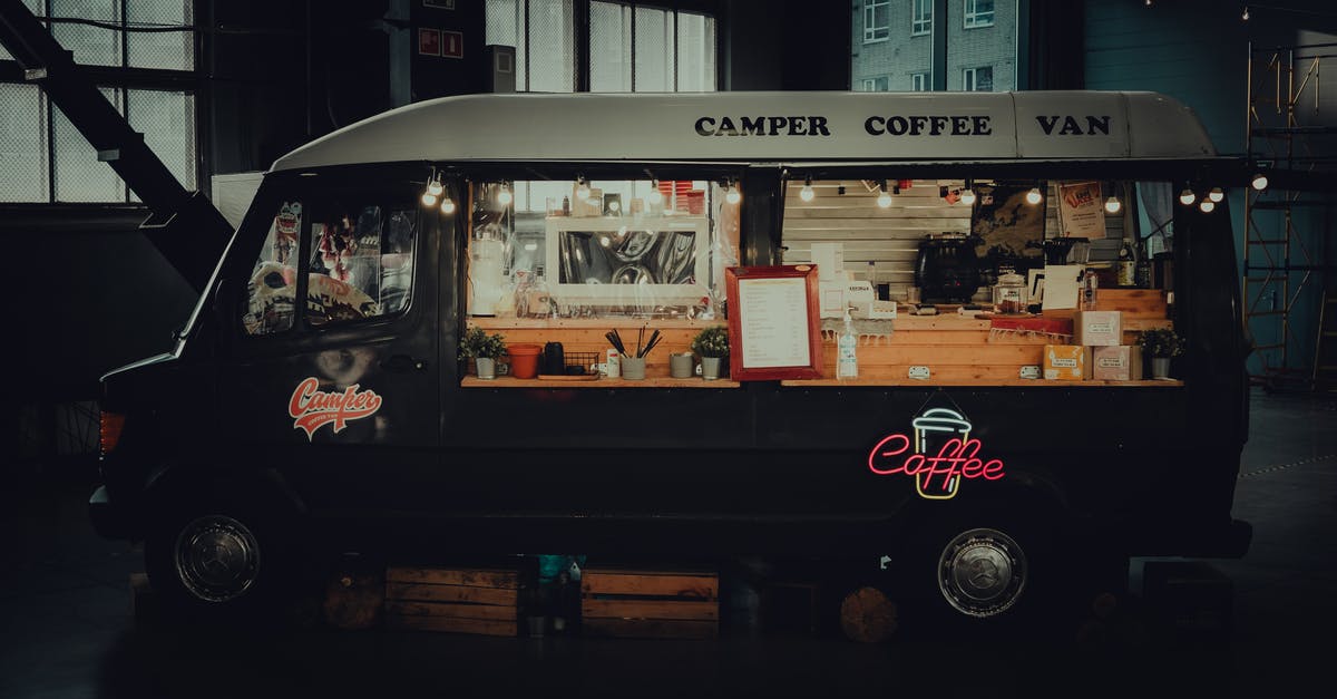 How late are restaurants open until in Italy? (Bologna specifically) - Contemporary black coffee van with inscriptions and sparkling signboard in late dark evening