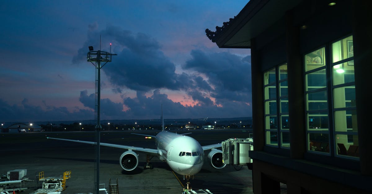 How late can I board a plane waiting at the gate? - Aircraft parked near airport terminal at night