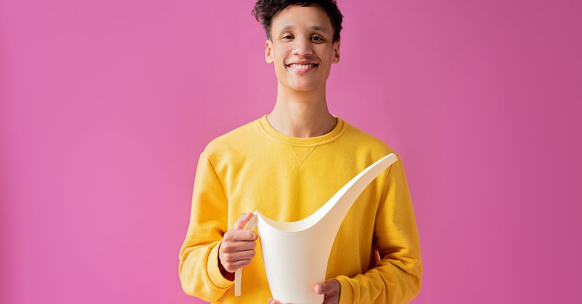 How long can I be in Belarus without having to register? - A Handsome Young Man Holding a Long Spout Plastic Watering Can