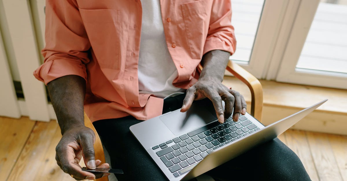 How long does a Ryanair payment stay pending? - A Man Sitting on a Wooden Chair Shopping Online