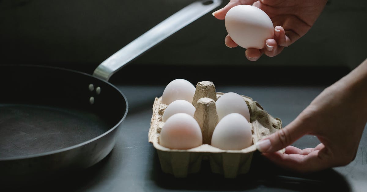 How long does it take for German consulates to process visa appeals? - High angle of crop anonymous housewife taking raw chicken egg from paper container for preparing breakfast in kitchen