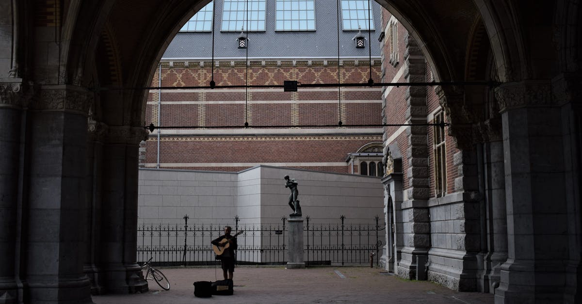 How long does it take to bike to Marken Island from Amsterdam - Person Playing Guitar on Street