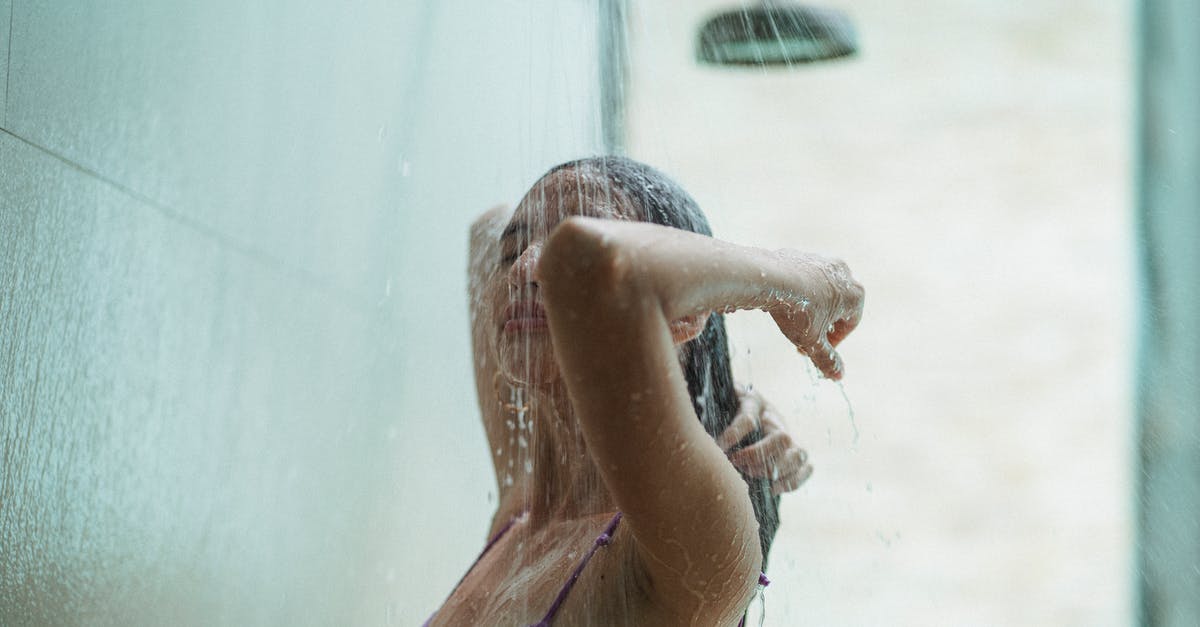 How long is an acceptable shower in Spain? [closed] - Young female in swimsuit rinsing hair in shower