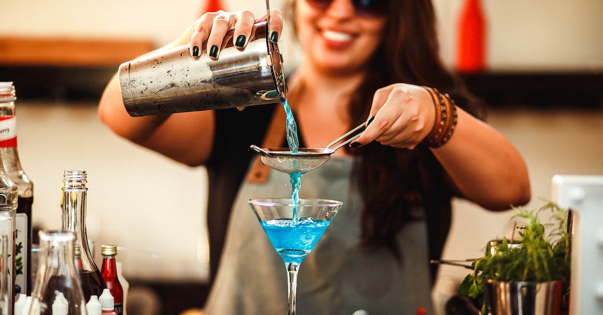 How long is the process to obtain a French working holiday visa as an Australian? - Crop cheerful woman preparing homemade blue cocktail in bar