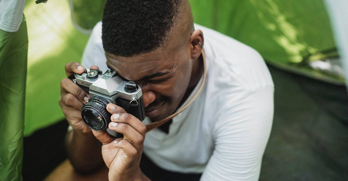 How long would it take to hike from Hamar to Lillehammer? - Black male hiker photographing on retro photo camera