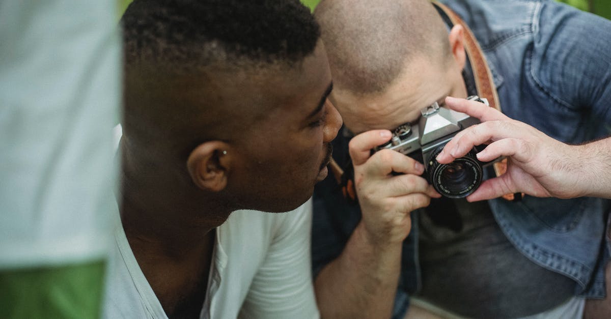 How long would it take to hike from Hamar to Lillehammer? - Man taking photo on camera while hiking with black friend