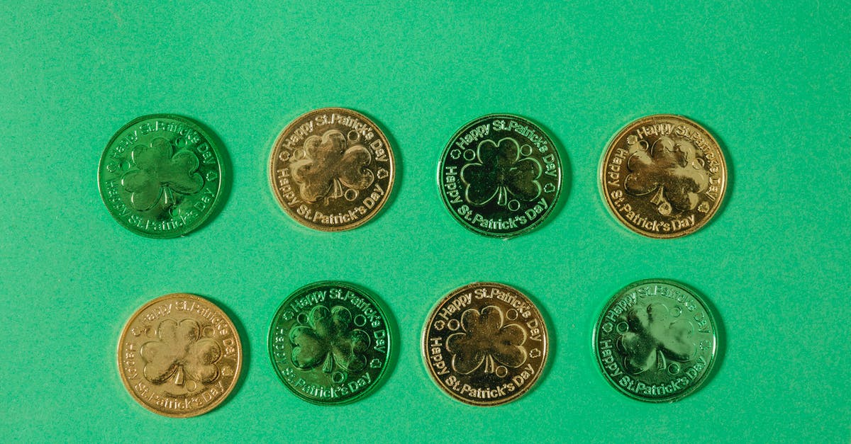 How many coin cell batteries can I take on EU flight? - Top view of gold coins with clover pattern arranged in rows on light green surface