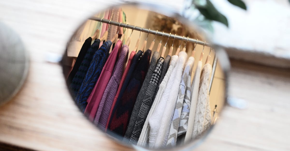 How many items can one buy and bring back home from Japan? - Clothes hanging on rack in reflection of mirror
