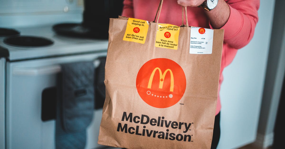 How many people buy First or Business class tickets out-of-pocket? - Man Holding A Mcdonald's Paper Bag