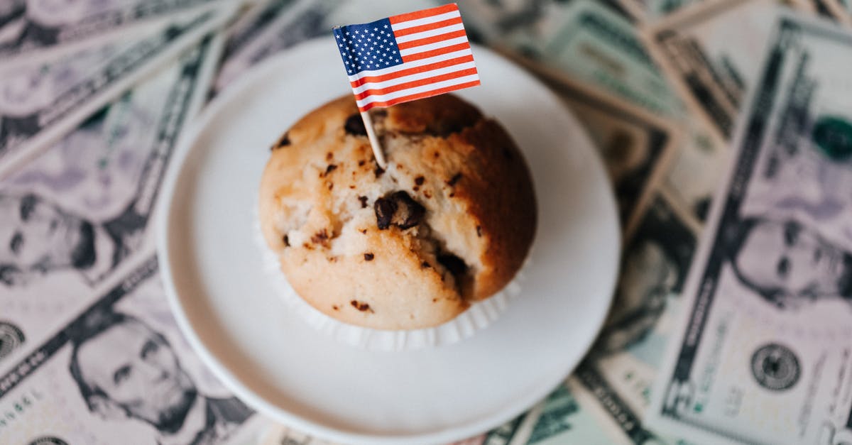 How many tents per campsite in US national parks? - Tasty cake with flag on bunch of paper dollars