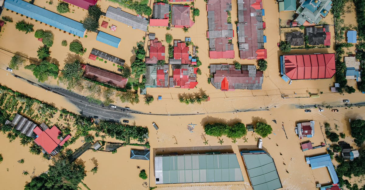 How many years am I banned from entering the Schengen Area? - Residential houses and green trees in flooded village