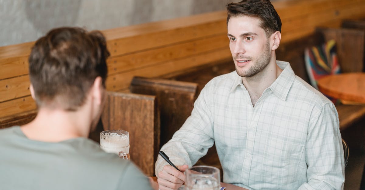 How much alcohol may I import into the Netherlands? - Business partners talking while signing agreement at table with beer