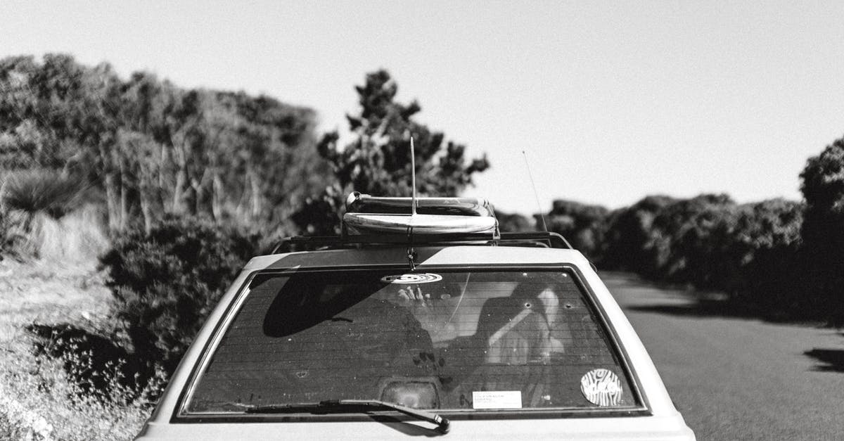 How much do roof racks hurt gas mileage? - Old car on road between lush trees in sunlight