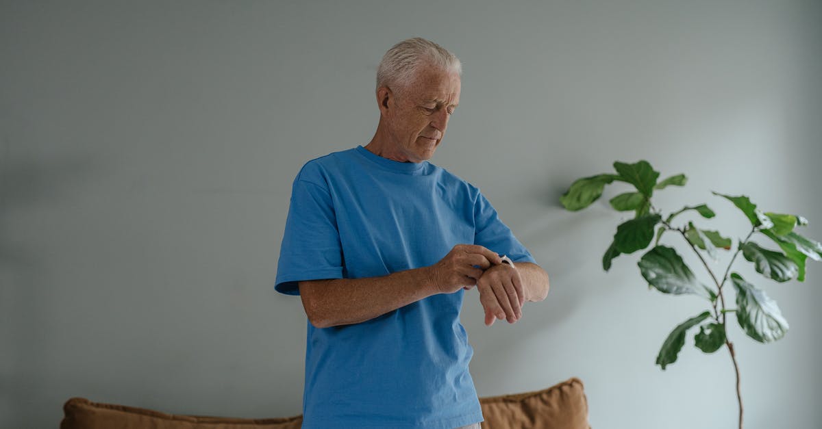 How much time is needed in FRA? - Man in Blue Crew Neck T-shirt Standing Near Brown Sofa