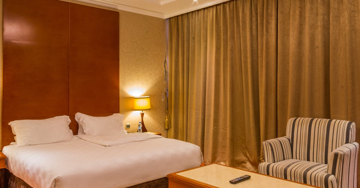 How much to haggle for a hotel room in India? - White Bed Linen and Brown Wooden Bed Frame