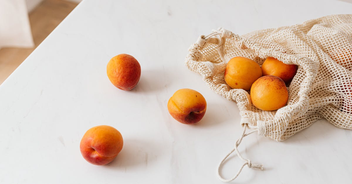 How much to tip for a free meal in Mexico? - Organic sweet apricots in cotton sack placed on table