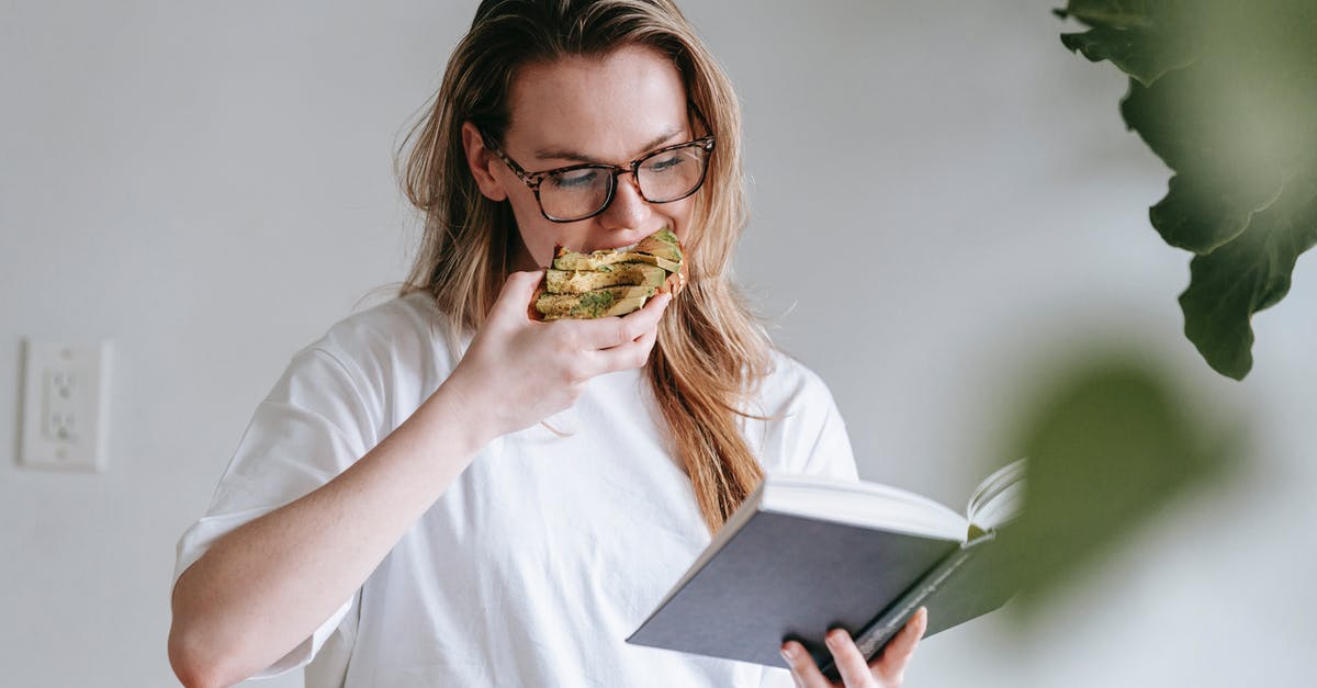 How much to tip for a free meal in Mexico? - Young woman with book and toast