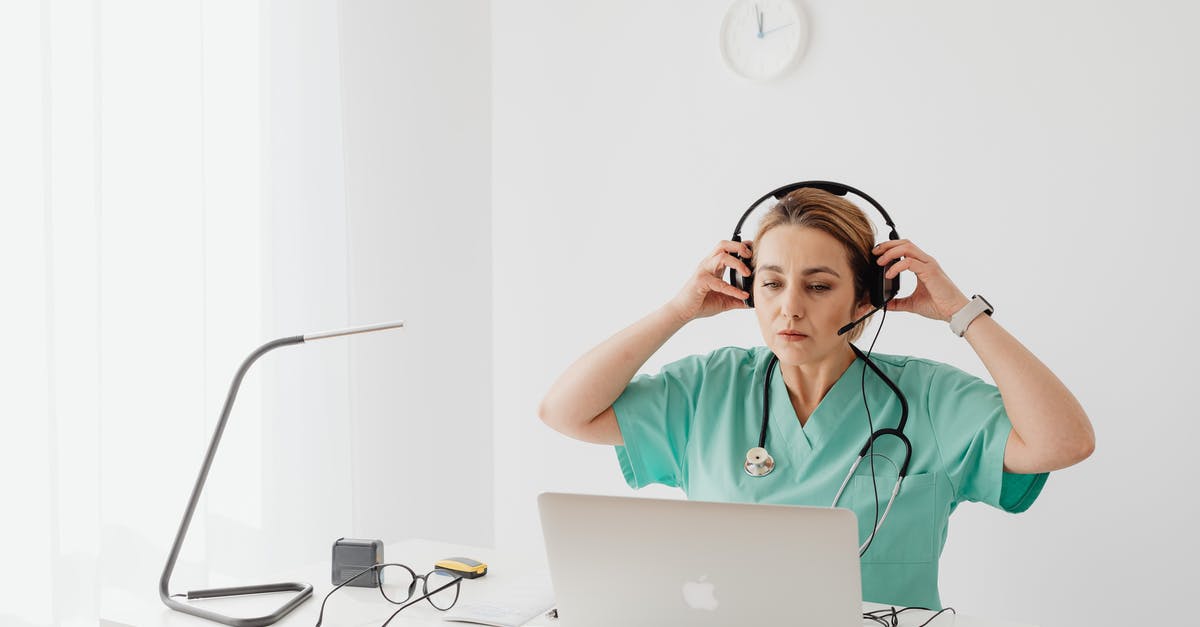 How reliable are portable WiFi hotspots in Japan? - A Woman in Teal Shirt Wearing Headset while Looking at the Laptop