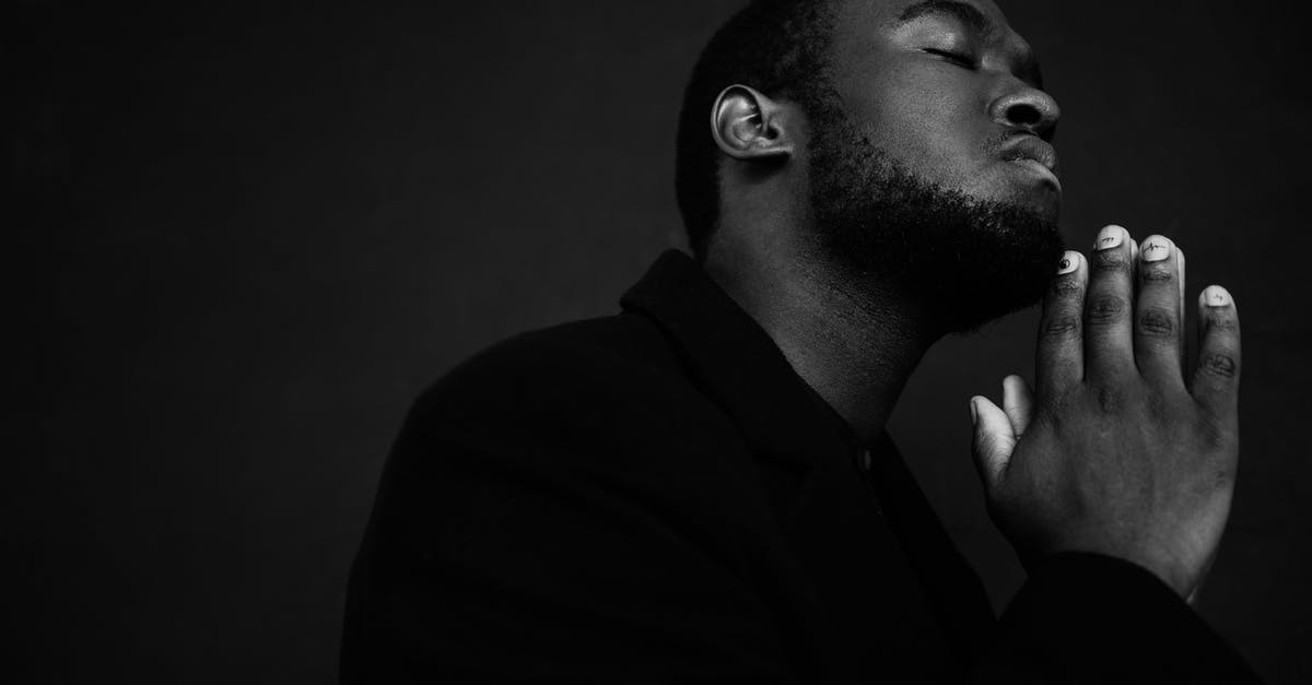 How serious is an expired passport? [closed] - Monochrome handsome unshaven African American male in black suit praying with hands clasped under chin