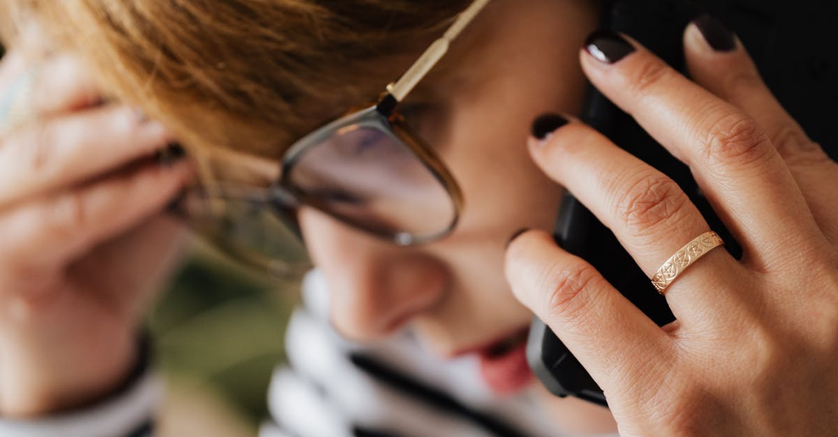 How seriously busy is Seville during the holy week? [closed] - Thoughtful female speaking on smartphone while working remotely