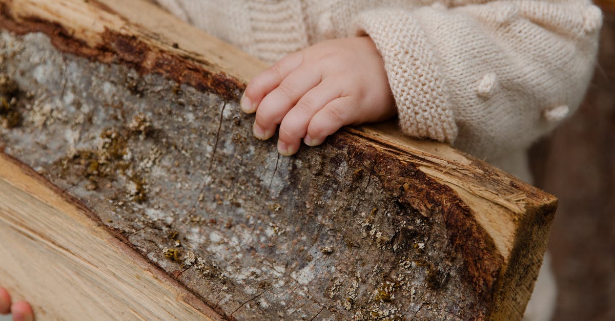 How should I prepare for a trip to China? - Anonymous kid preparing wooden pieces for fire