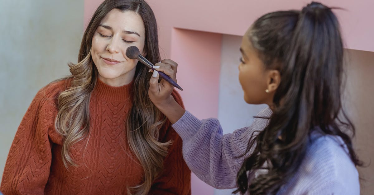 How to apply for a Schengen visa? [closed] - Young ethnic lady applying foundation on face of friend with brush