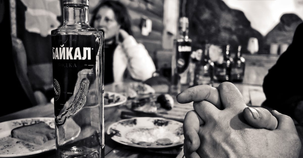 How to avoid drinking vodka? - Grayscale Photography of Bottle Beside Saucer