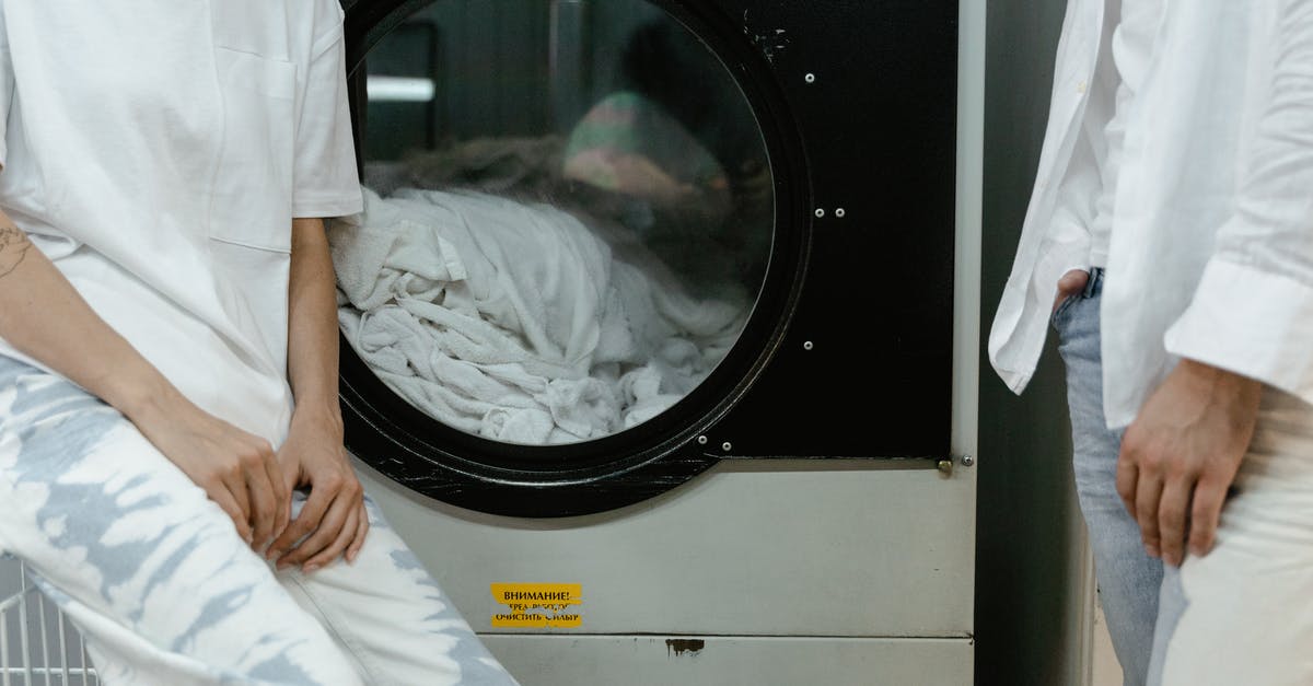 How to avoid to get your clothes to disappear in Indonesian laundry services? - People Wearing White Tops near a Washing Machine
