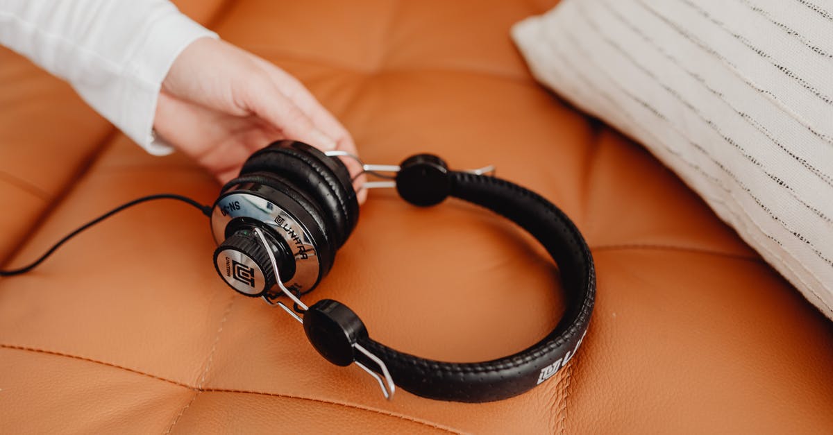 How to bring big electronics in aeroplane? [duplicate] - Person Holding Black and Silver Headphones