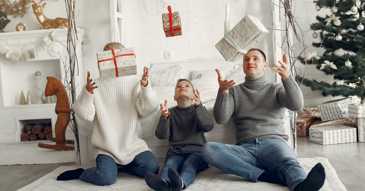 How to bring non-EU parents to live in the UK? [closed] - Family Sitting on Floor and Enjoying Christmas Gifts