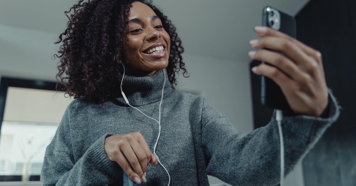 How to cancel an ADO online reservation? - Woman in Gray Sweater Holding Iphone