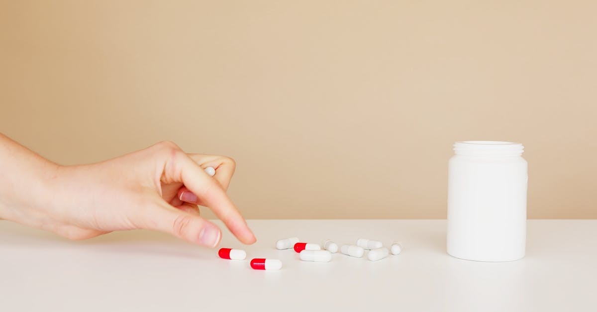 How to carry cologne bottles in hand luggage and prevent losses? - Crop patient taking pill from table