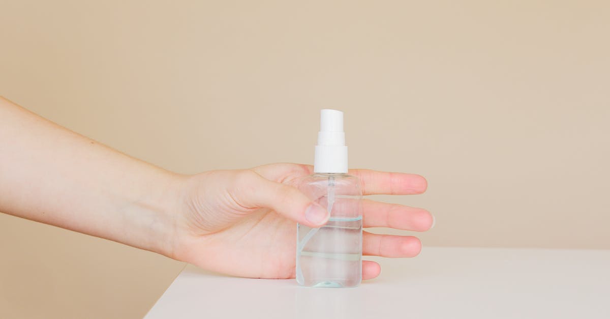 How to carry cologne bottles in hand luggage and prevent losses? - Crop woman taking bottle of antiseptic from table