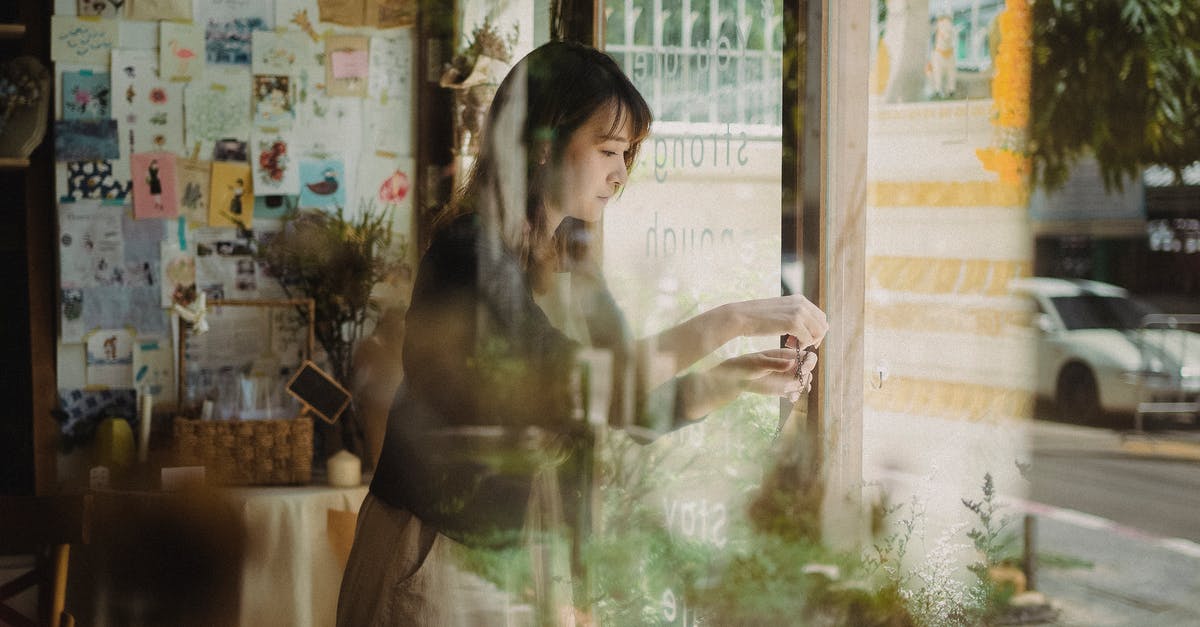 How to choose a cafe/coffee shop when travelling? - Pensive woman standing in cozy shop