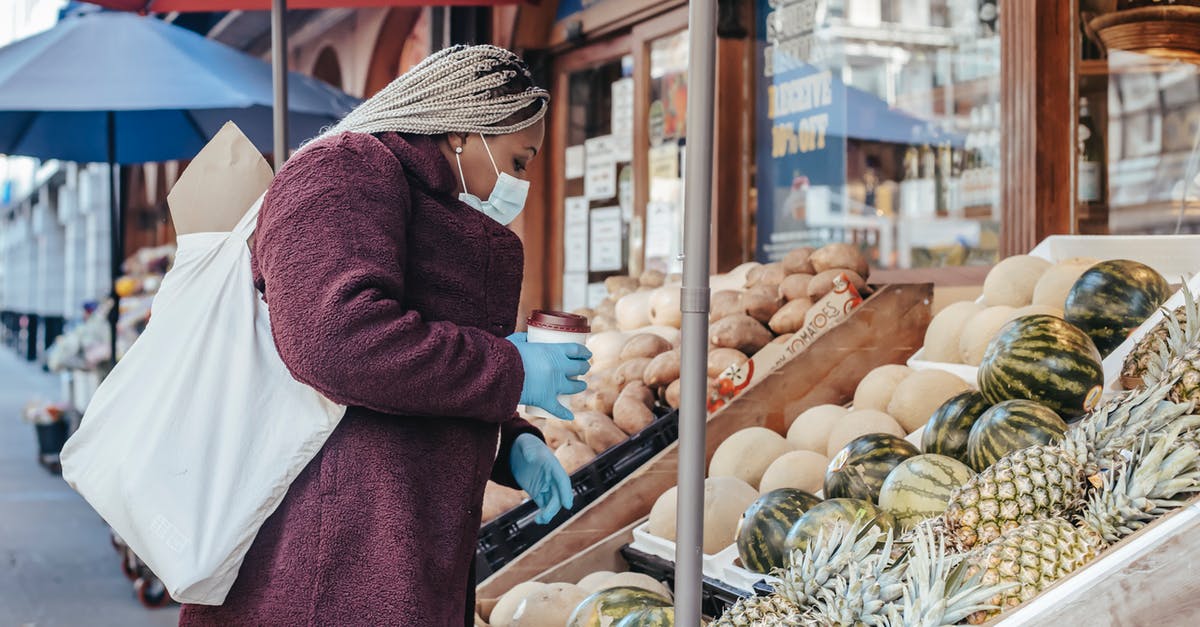 How to choose a cafe/coffee shop when travelling? - Black woman with coffee picking fruits in stall