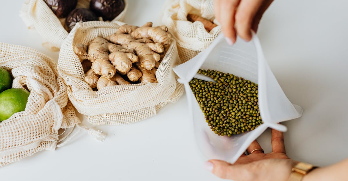 How to combine multiple bags into a single checked item? - Person Holding Brown and White Nuts