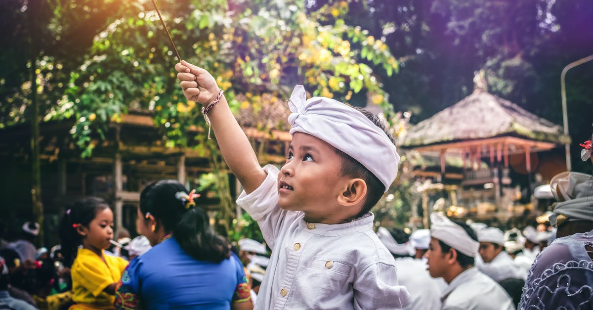 How to connect between Indonesian Air Asia and Jetstar at Denpasar (Bali) airport? - Boy Holding Sparkler