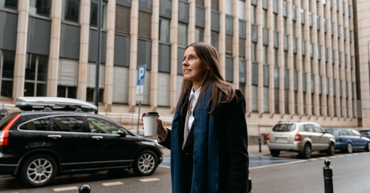 How to divide large bank notes into smaller ones while traveling? - Woman in Black Coat Standing on Sidewalk