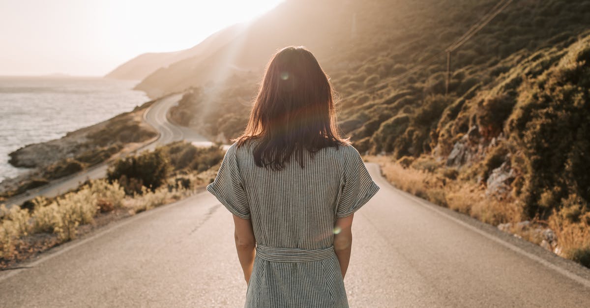 How to estimate duration of road trip for vacations? - Woman in Blue and White Dress Standing In The Middle Of A Road