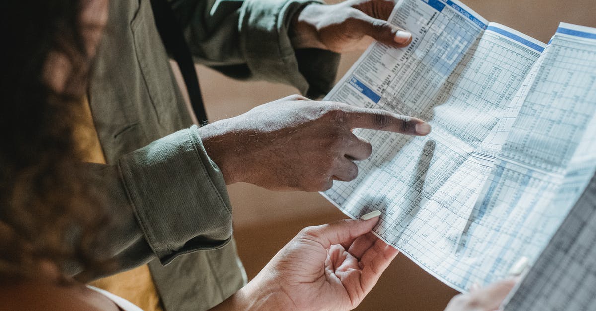 How to explain allowance received without any document from employer? - From above of crop unrecognizable black man showing paper with tables to woman in daytime