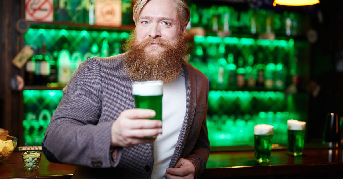 How to extend my national visa in Poland by one day? - Bearded Man in Gray Suit Holding Green Beer