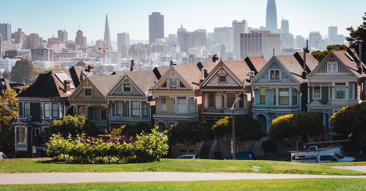 How to find affordable extended-stay accommodation in Latin America - Exterior of typical cozy similar residential houses located in peaceful suburb area of San Francisco against modern skyscrapers on sunny day