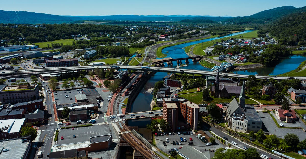 How to find mountain parking in Switzerland? - Contemporary bridge over water channel and railway in town