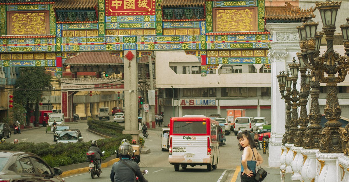 How to find sightseeing places around the driving road Stockholm-Trondheim with a car? Any iPhone application to investigate the area? - Various vehicles riding on street near traditional buildings in Binondo district located in Manila