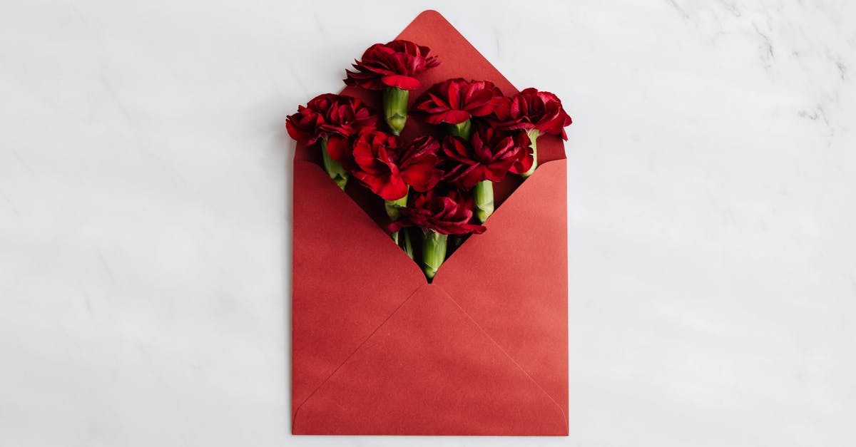 How to find someone to (once) pick up and re-send an envelope in Cancun? [closed] - Top view of opened red envelope with beautiful red carnations against white background symbolizing congratulation concept