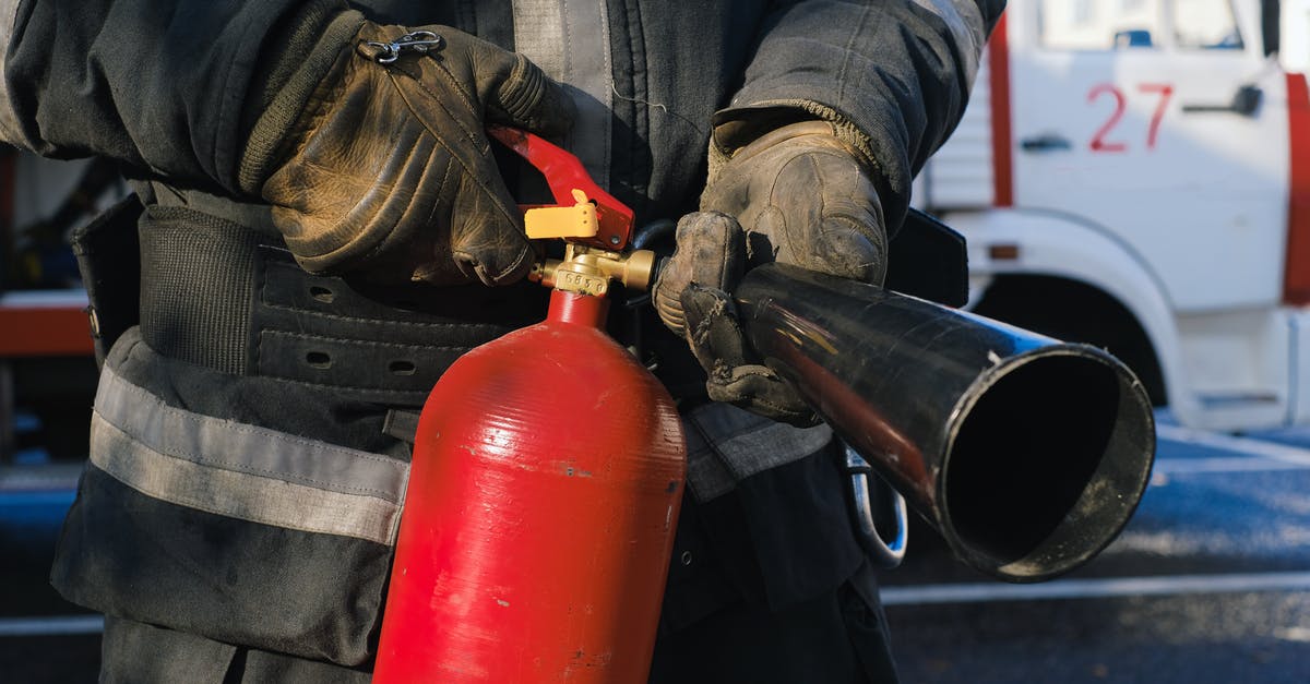 How to find where there are safety issues in Paris? - Person in Blue Denim Jacket Holding Red and Black Water Jug